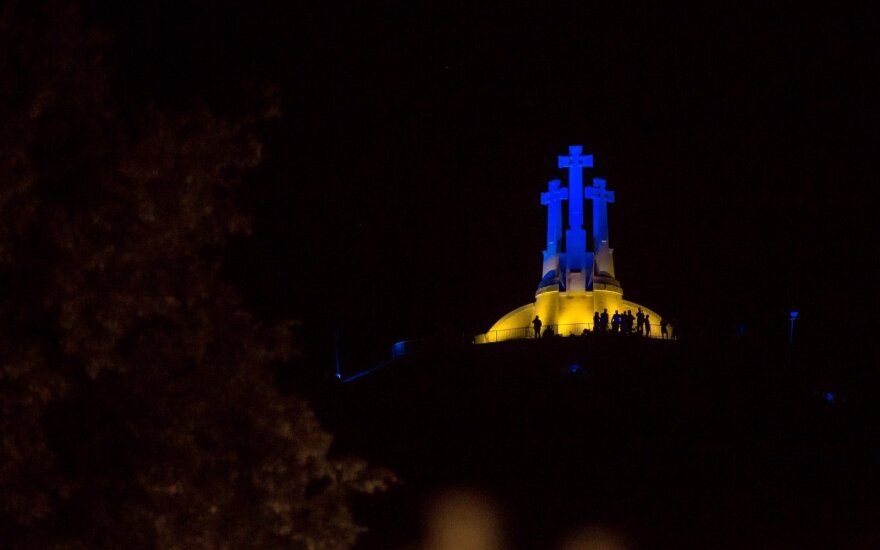 Three Crosses Hill lit with the colours of the Ukrainian flag